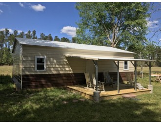 Metal Hunting Cabin | Boxed Eave Roof | 24W x 36L x 9H | Lean-to Porch